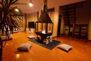 a living room with a fireplace on a wooden floor at Mountain Home Bran in Bran