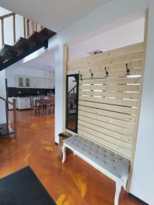a white bench in a room with a table at Mountain Home Bran in Bran +50 photos