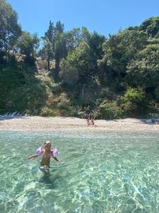 a person standing in the water at a beach at Thalia Estate in Agios Spyridon Corfu