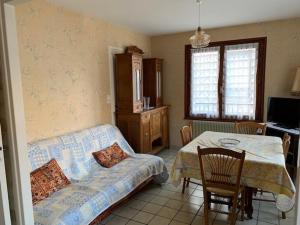 a bedroom with a bed and a table with a chair at Appartement Mont-Dore, 2 pièces, 4 personnes - FR-1-415-31 in Le Mont-Dore