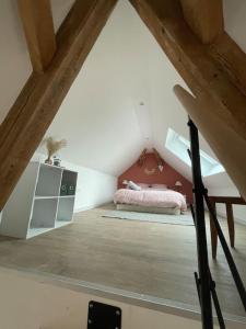 a attic bedroom with a bed in a attic at La Grange proche d’Europapark in Kunheim