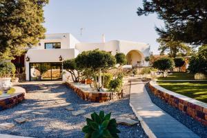 a house with a garden in front of it at Ocean Suites in San Antonio Bay