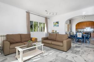 a living room with two couches and a table at Villa Sabita - PlusHolidays in Calpe