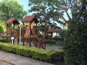 a playground in a park with a wooden play structure at Eli 2 Sea View apartment first line in Nesebar