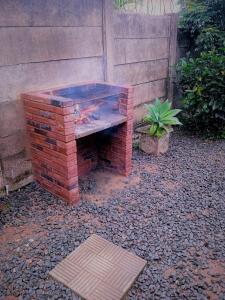 a brick bench sitting next to a wall at East-Coast Guesthouse: Serene, Private, Secure in Durban
