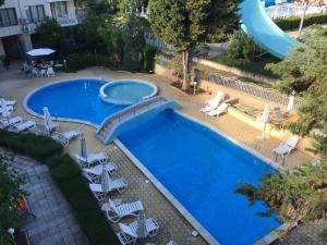 an overhead view of a swimming pool with chairs and a slide at Eli 2 Sea View apartment first line in Nesebar