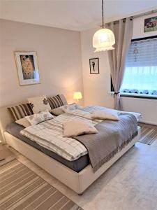 a bedroom with a large bed in front of a window at Haus Schluchseeblick in Schluchsee