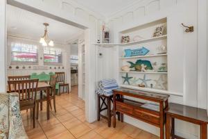 a dining room and kitchen with a table and chairs at The Seashell Cottage in Anna Maria
