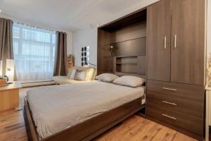 a bedroom with a large bed and a large cabinet at Initial / Aube / Québec in Quebec City