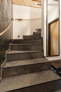 a staircase in a house with black stairs and a wall at Oczko Na Giewont in Kościelisko