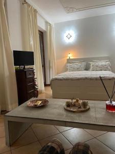 a bedroom with a bed and a table with food on it at Casa Vacanze AndQuote - ROMA in Marco Simone