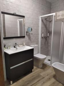 a bathroom with a sink and a shower and a toilet at La Teja del Jerte in Aldehuela del Jerte +25 photos