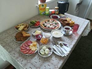a table with a bunch of breakfast foods on it at Kayyr Guest House in Orgochor