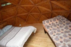 a bedroom with a bed in a wooden room at cabaña tipo domo 100% equipado in Nobsa