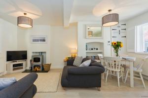 a living room with two couches and a table at CROYDE VICTORIA COTTAGE 2 Bedrooms in Croyde