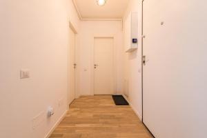 a hallway with white walls and a wooden floor at Maria in Bucharest