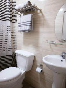 a bathroom with a white toilet and a sink at Casa Cecilia-Entire house located near 100 Islands in Alaminos