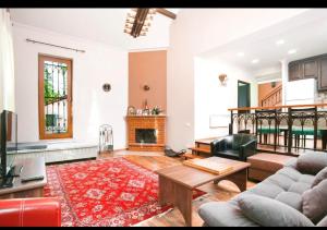 a living room with a couch and a fireplace at Dilijan Dream House! 3 Bedroom Amazing Villa in National Park! in Dilijan