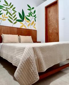 a bedroom with a bed with a wooden headboard at Piccolo Bed & Breakfast in Tarapoto
