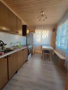 a kitchen with a sink and a table in it at Гостинний двір Матійчуків Новий in Vorokhta