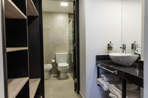 a bathroom with a sink and a toilet at HOTEL M in Mendoza