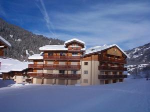 a large building with snow on top of it at Appartement Châtel, 3 pièces, 6 personnes - FR-1-198-140 in Châtel