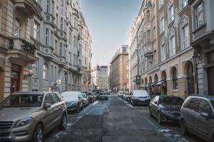 a city street with cars parked on the sides of buildings at Prince Matyas apartment in Prague