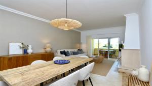 a living room with a wooden table and chairs at Adam's Place (Garça Real)CD242 - Clever Details, Sleeps 4 people, Wifi, Garage in Vilamoura