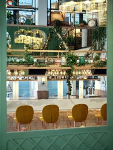 a view of a restaurant with chairs and a counter at Royal Madeleine Hotel & Spa in Paris