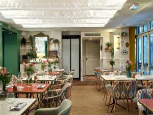 a dining room with tables and chairs at Royal Madeleine Hotel & Spa in Paris