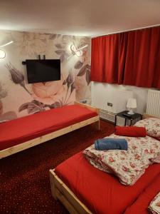 a bedroom with two beds and a flat screen tv at City-Apartments Hamburg in Hamburg