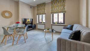 a living room with a couch and a table at Apartamenty VIP Zdrojowa 6 (deptak) by Royal Aparts in Świeradów-Zdrój