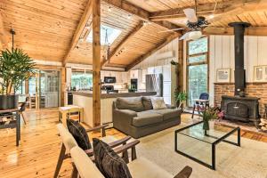 a living room with a couch and a stove at Rustic-Chic Home with Decks Pool and Lake Access in Otis