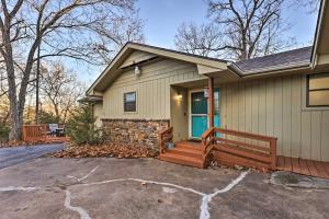 a house with a front porch with a wooden deck at Holiday Island Home Mountain View and Hot Tub! in Holiday Island