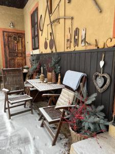 a patio with a table and chairs and a christmas tree at Pension Laura in Chřibská