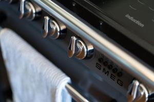 a close up of an oven with towels on it at Luxury Duplex Penthouse on the Beach with Panoramic Sea Views in Herne Bay