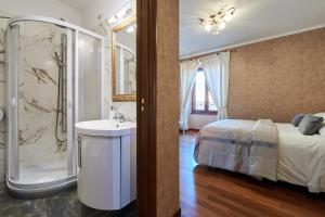 a bathroom with a bed and a sink and a shower at Le Suite Downtown in Rome
