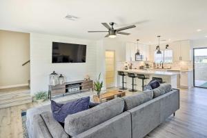a living room with a couch and a kitchen at Modern Fountain Hills Townhome with Private Patio! in Fountain Hills