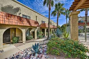 a building with palm trees and a walkway at Modern Fountain Hills Townhome with Private Patio! in Fountain Hills