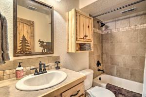 a bathroom with a sink and a toilet and a mirror at 22STR-00367 Fairplay Cabin ~ 6 Mi to Downtown! in Fairplay +21 photos