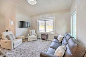 a living room with a couch and chairs and a tv at Sleek Ludington Haven Less Than 1 Mi to Lake Michigan in Ludington