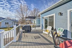 a deck with two chairs and a table on a house at Sleek Ludington Haven Less Than 1 Mi to Lake Michigan in Ludington