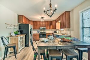 a kitchen with a table and chairs and a refrigerator at Beautiful Clarkesville Home about 8 Mi to Helen! in Clarkesville