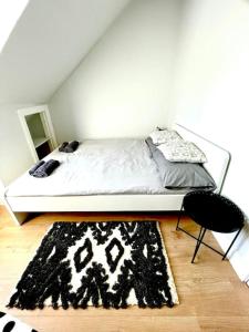 a bedroom with a bed with a black and white rug at Loft apartment in Joppa in Edinburgh