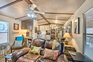 a living room with a leather couch and a ceiling fan at Lake-View Getaway in Sherrills Ford with Deck! in Denver