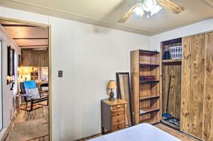 a bedroom with wooden walls and a bed and a chair at Lake-View Getaway in Sherrills Ford with Deck! in Denver