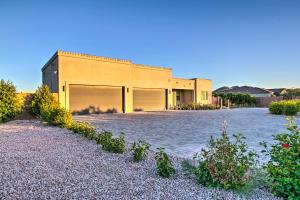 a house with a large driveway in front of it at Phoenix Home with Desert Views and Garden-Style Yard in Anthem
