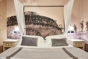 a bedroom with a bed with a black and white headboard at Le Suite Downtown in Rome