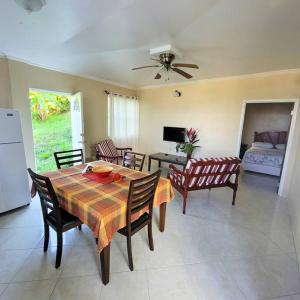 a living room with a table and chairs and a bedroom at 1 Bed Apt overlooking Rodney Bay in Gros Islet
