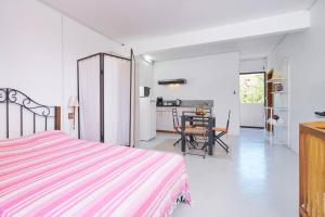 a bedroom with a bed and a dining room at Cosy Studio #2 - Pereybere in Pereybere